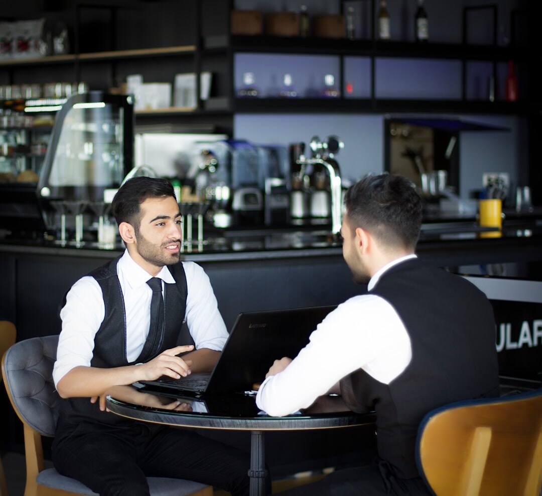 Professional Turkish male technology analyst in a business setting