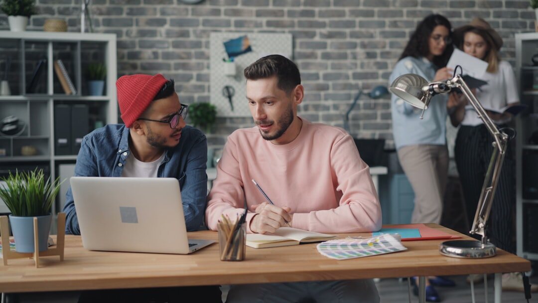 Modern startup office with young entrepreneurs working on computers