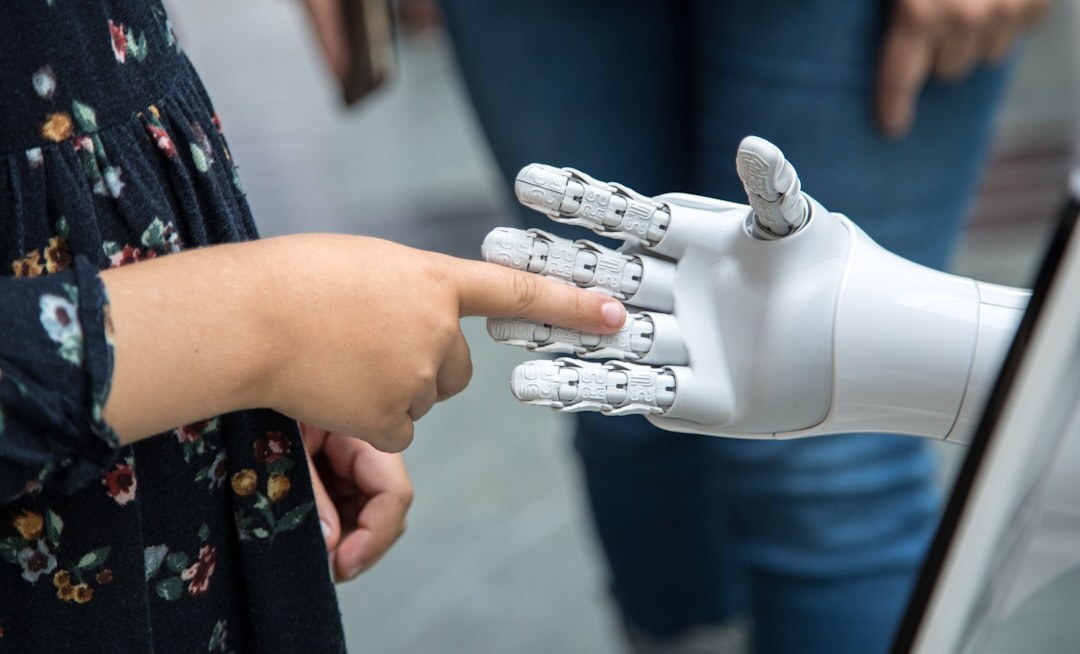 Robot hand reaching toward human hand in a symbolic gesture of AI and humanity